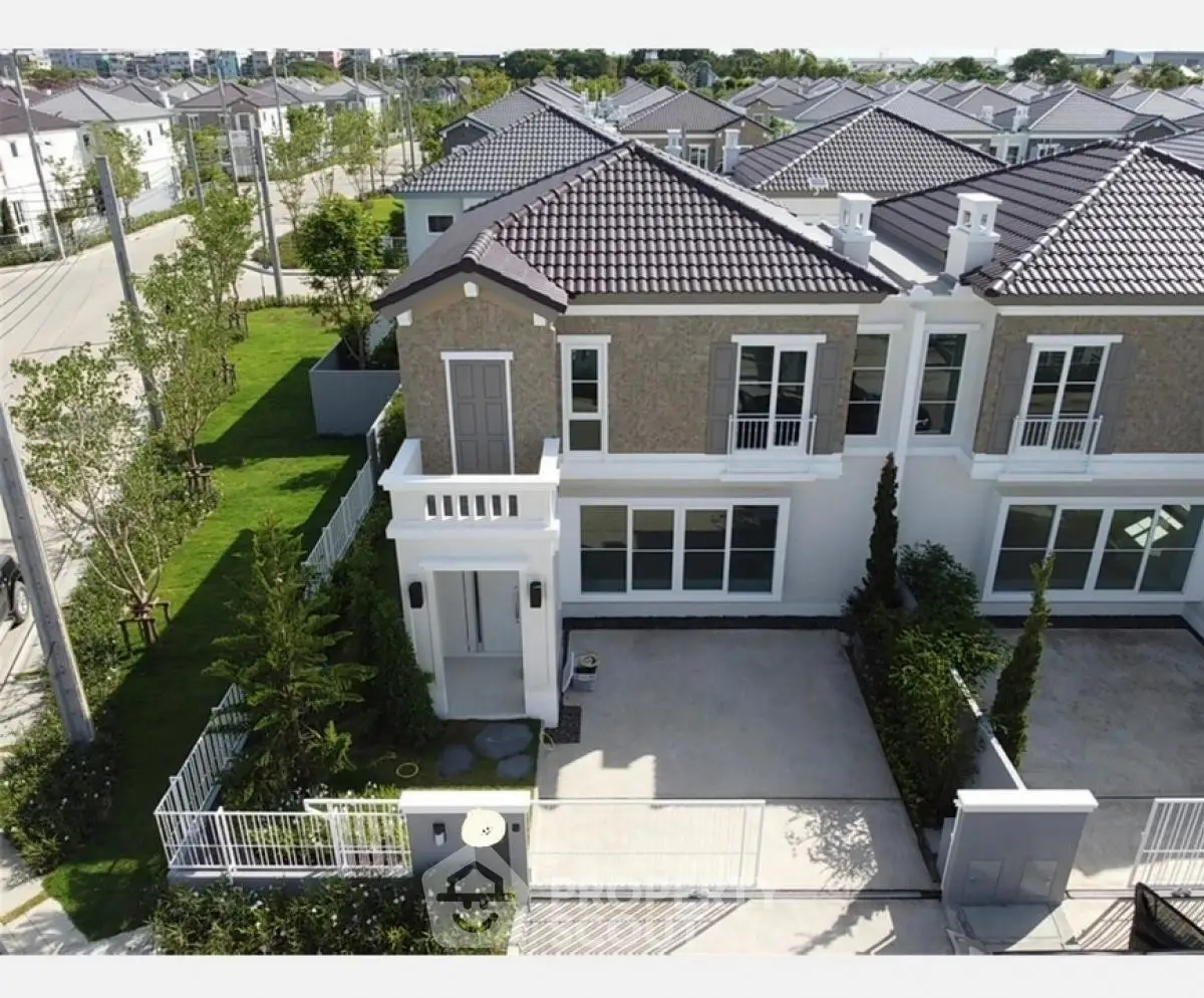 Elegant two-story house with modern design and spacious driveway in a serene neighborhood.