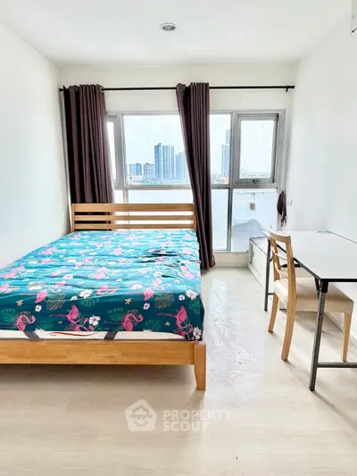 Bright bedroom with city view, featuring modern furniture and large windows.