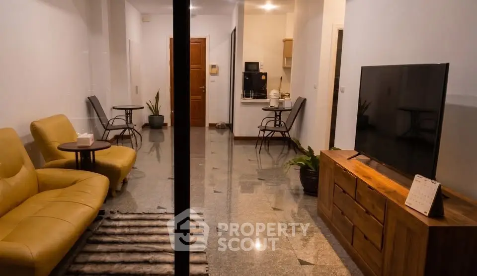 Stylish living room with modern furniture and open kitchen layout, perfect for cozy living.