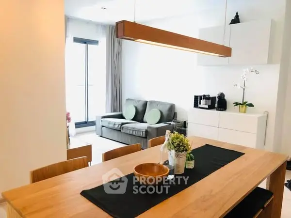 Modern dining area with wooden table and cozy living space