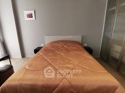 Cozy bedroom with modern decor and stylish bedding in a contemporary apartment.