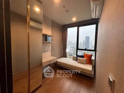 Modern bedroom with city view, featuring sleek design and cozy furnishings.
