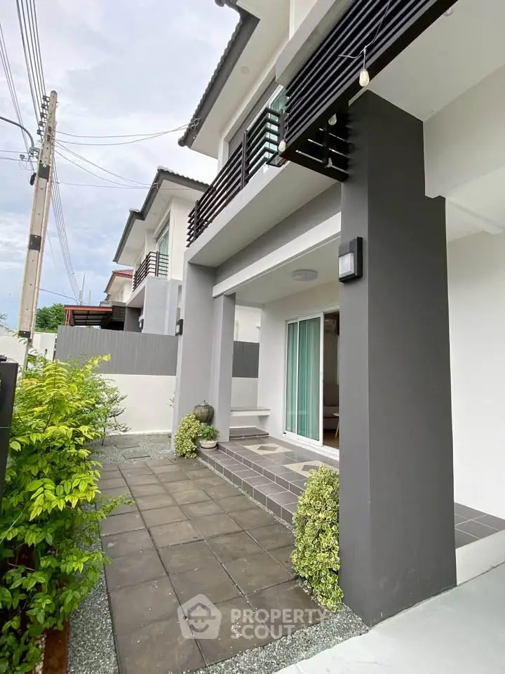 Modern two-story house with sleek exterior and stylish balcony