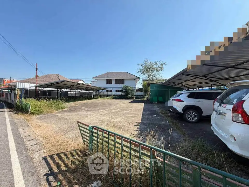 Spacious parking area with covered spaces in a residential neighborhood.