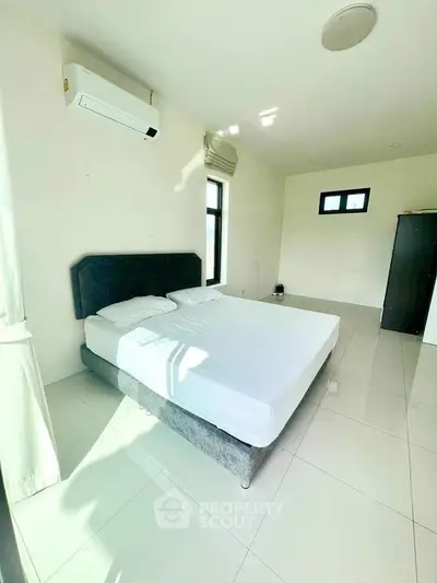 Spacious bedroom with modern air conditioning and natural light