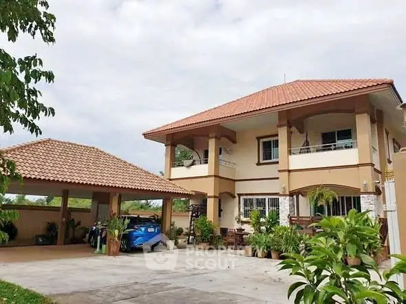 Charming two-story house with spacious driveway and lush greenery, perfect for family living.
