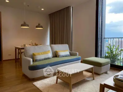 Modern living room with stylish furniture and large window offering city view