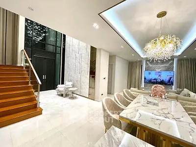 Luxurious modern living room with elegant dining area and stunning chandelier