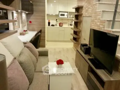 Modern living room with cozy seating and stylish kitchen in open layout apartment.
