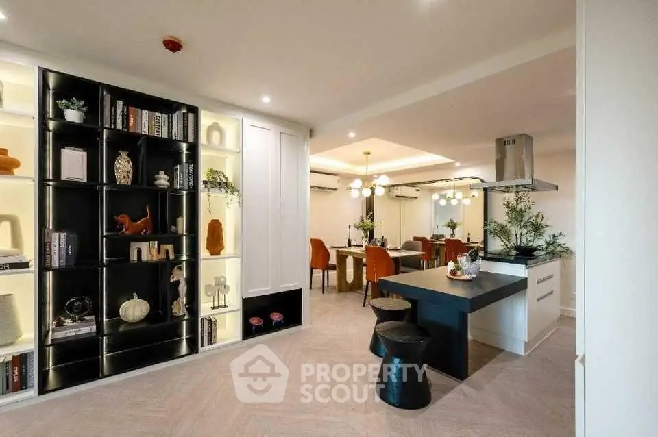 Luxurious open-plan living and dining area with modern decor and stylish lighting.