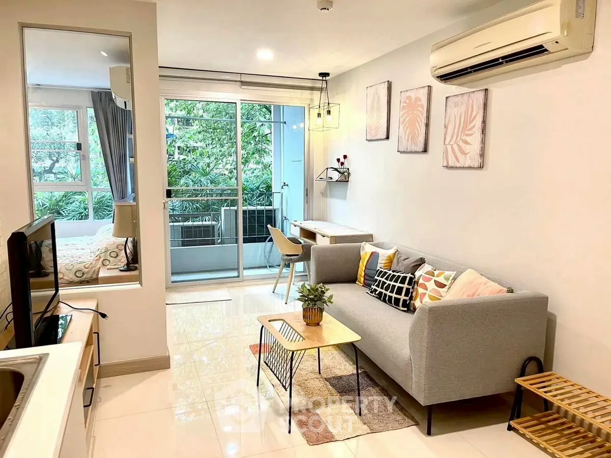 Modern living room with balcony, stylish decor, and natural light