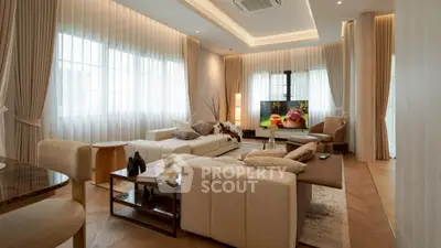 Luxurious living room with elegant decor and large windows, perfect for relaxation and entertainment.