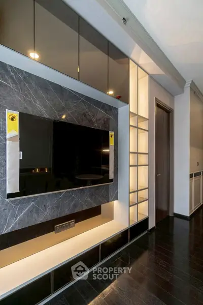 Modern living room with sleek TV wall unit and ambient lighting