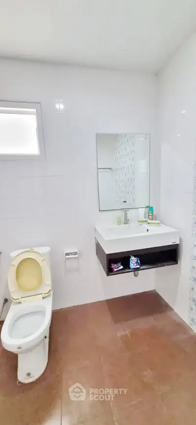 Spacious bathroom with modern fixtures and large mirror