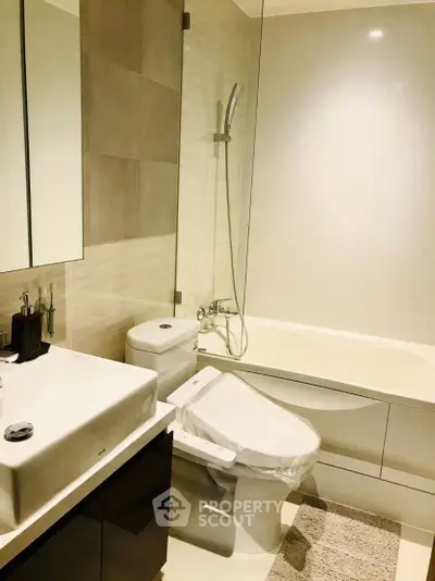 Modern bathroom with sleek fixtures and bathtub in elegant apartment.