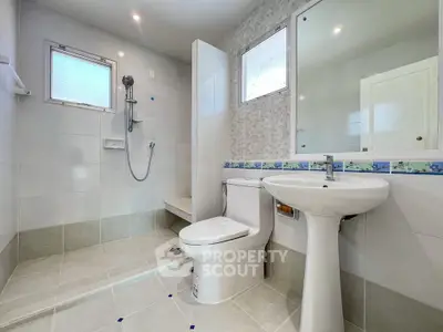 Modern bathroom with sleek fixtures and spacious shower area