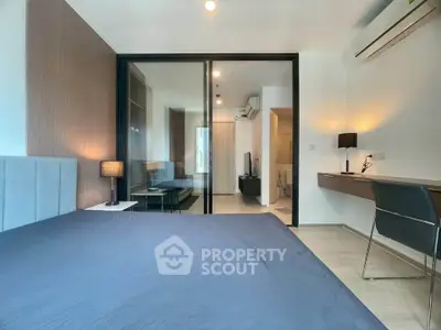 Modern bedroom with sleek design and glass partition in a stylish apartment