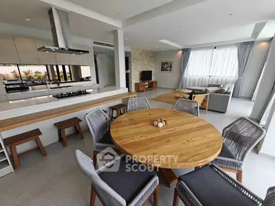Spacious modern living room with open kitchen and stylish dining area, perfect for entertaining.