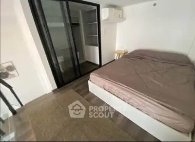Modern bedroom with sleek glass closet doors and minimalist decor