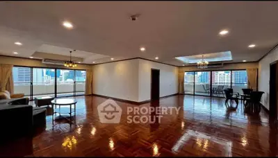 Spacious luxury living room with city view and elegant wooden flooring