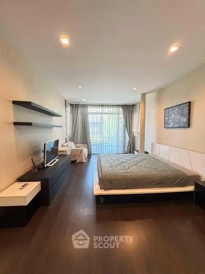 Spacious modern bedroom with elegant decor and natural light