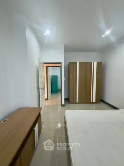 Spacious bedroom with modern wardrobe and sleek flooring