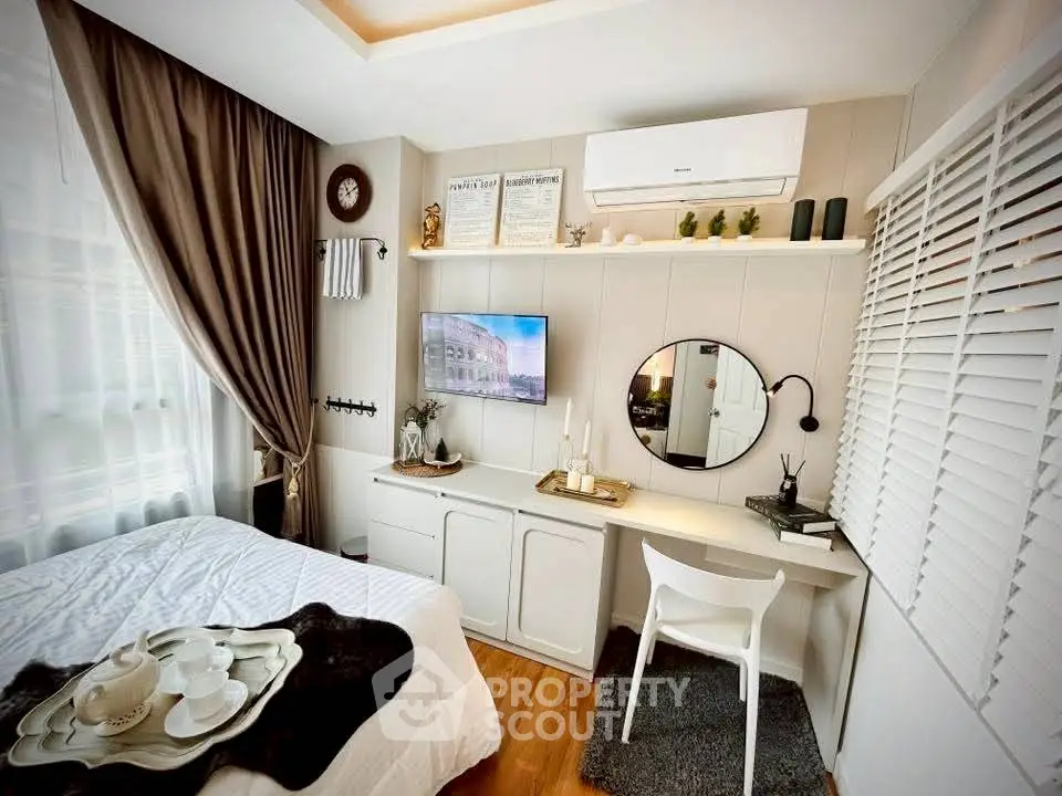 Chic bedroom with modern decor, cozy workspace, and elegant lighting, perfect for urban living.