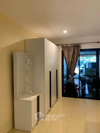 Spacious living room with modern storage and large window view