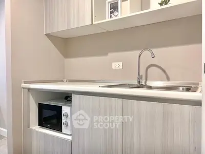 Modern kitchen with sleek cabinetry and built-in microwave