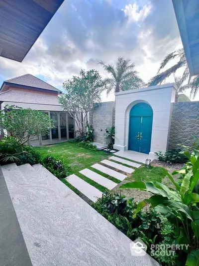 Luxurious garden entrance with modern architecture and lush greenery