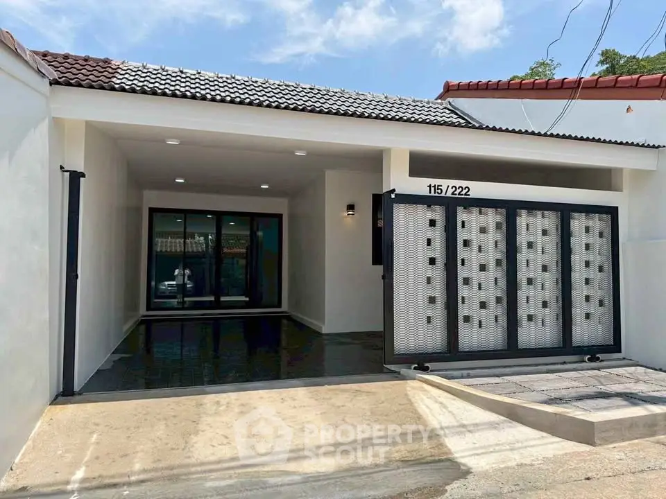 Modern single-story house with sleek gated entrance and spacious driveway.