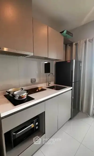 Modern kitchen with sleek cabinetry and built-in appliances in a stylish apartment.