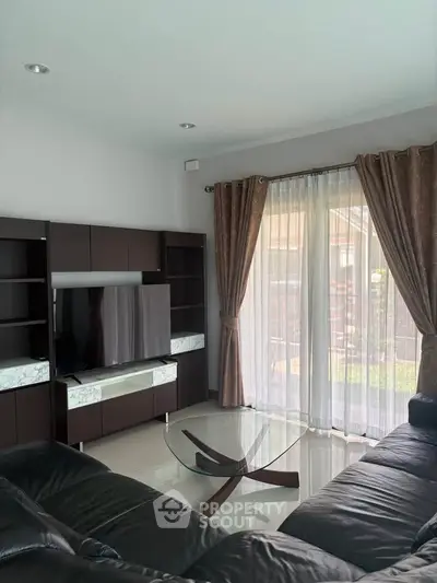 Spacious living room with modern furniture and large window for natural light