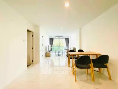 Spacious modern living room with dining area and large windows for natural light.