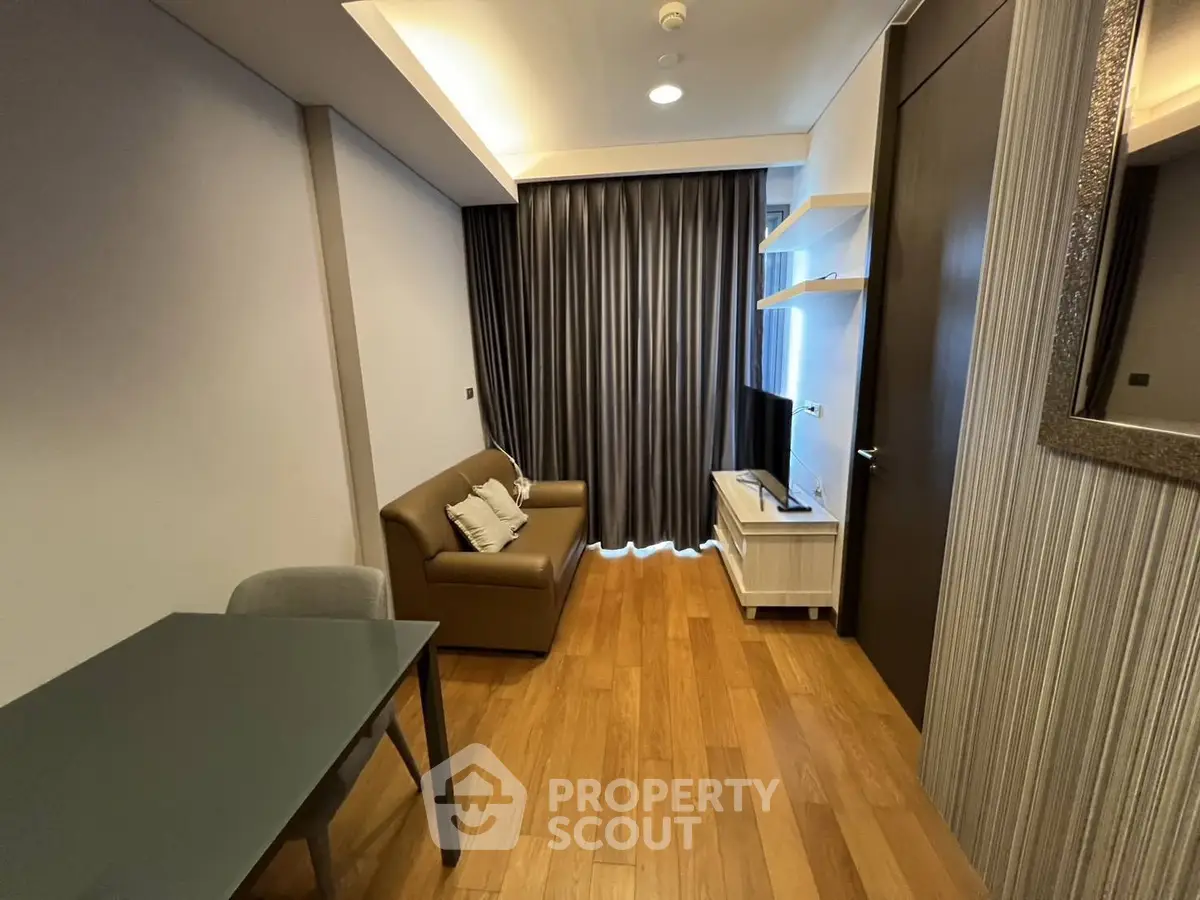 Modern living room with sleek furniture and wooden flooring, perfect for cozy urban living.