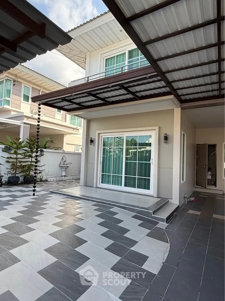 Modern house exterior with stylish tiled patio and large windows