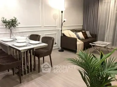 Stylish modern living room with elegant dining area and cozy sofa.