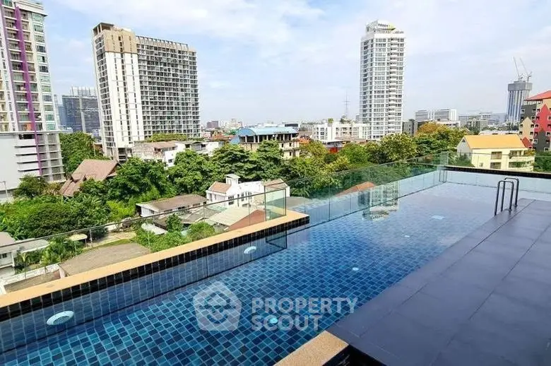 Stunning rooftop pool with panoramic city views in a modern urban setting.