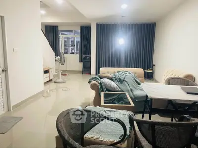 Spacious living room with modern furniture and large windows for natural light.