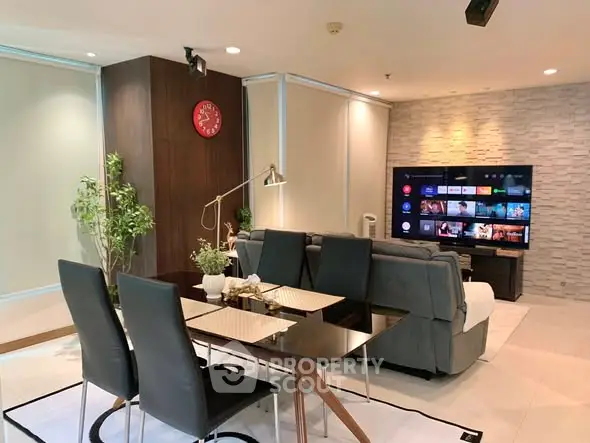 Modern living room with sleek dining area and large TV screen