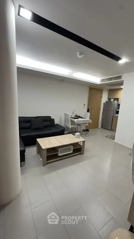 Modern living room with sleek furniture and open kitchen layout