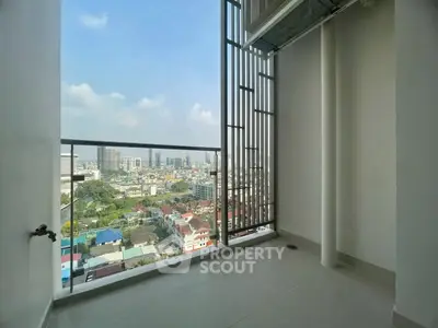 Spacious balcony with stunning city view in modern high-rise apartment