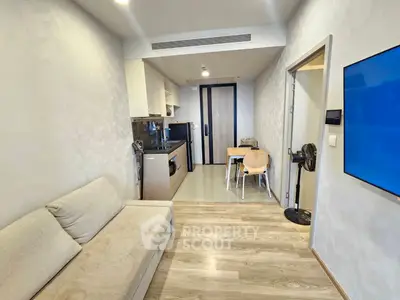 Modern compact living room with open kitchen and cozy seating area