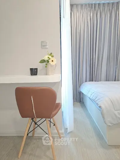 Modern bedroom with stylish chair and cozy bed setup
