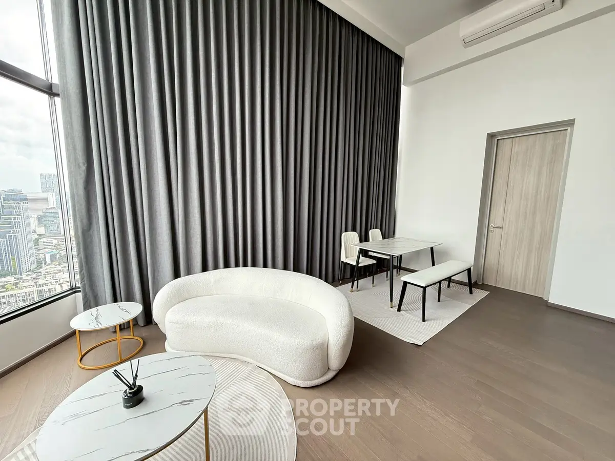 Luxurious high-rise living room with panoramic city views and modern furnishings.