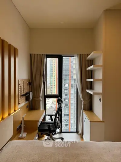 Modern study room with city view, ergonomic chair, and sleek wooden desk.
