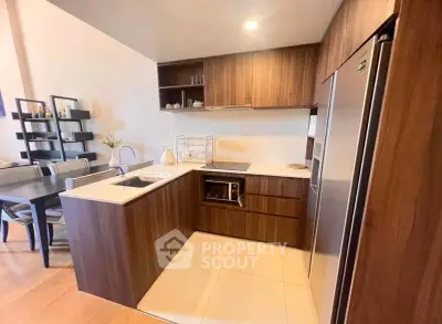 Modern kitchen with wooden cabinets and sleek appliances in open layout design.