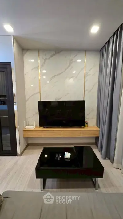 Modern living room with sleek TV setup and elegant marble accent wall