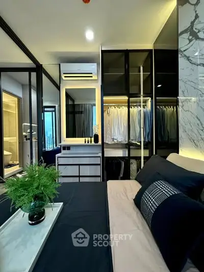 Luxurious bedroom with modern design, walk-in closet, and elegant decor in a high-rise apartment.