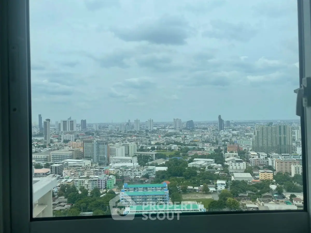 Stunning cityscape view from high-rise window showcasing urban skyline.